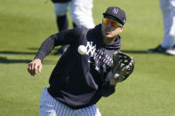 New York Yankees' Giancarlo Stanton catches a ball during a spring training baseball workout Tuesday, Feb. 23, 2021, in Tampa, Fla. (AP Photo/Frank Franklin II)