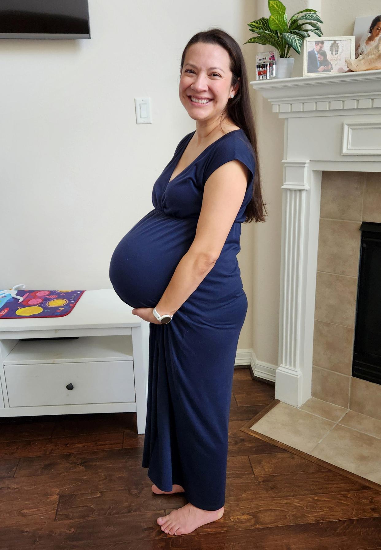 Mercedes Sandhu holds her pregnant belly in her home in Pearland, Texas, before giving birth to identical quadruplets.