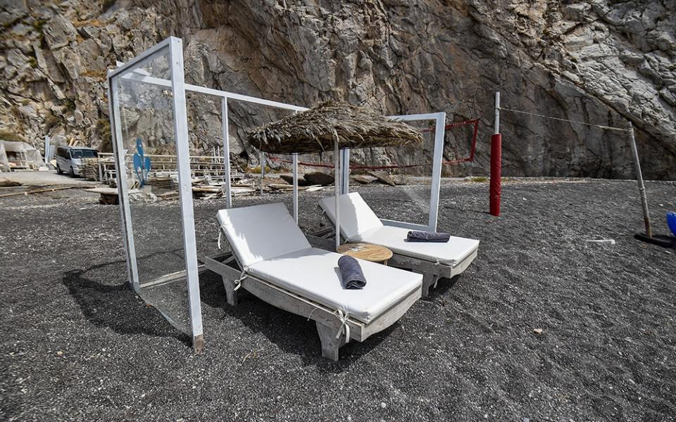 Plexiglass dividers on Perissa beach in Santorini