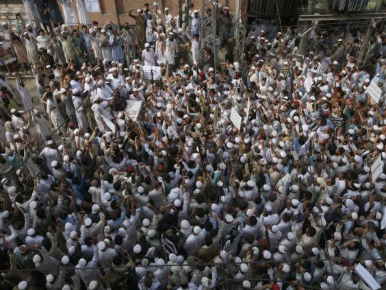 Supporters of a religious group chant slogan during a rally favouring the gunman who shot Tahir Naseem in courtroom, in Peshawar on Friday (AP Photo/Muhammad Sajjad)