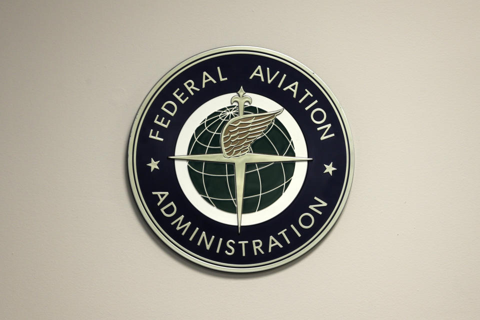 FILE - A Federal Aviation Administration sign hangs in the tower at John F. Kennedy International Airport in New York, March 16, 2017. The federal officials said Thursday, April 4, 2024, that they are investigating a Southwest Airlines flight that veered off course and flew close to the air traffic control tower at LaGuardia Airport last month. (AP Photo/Seth Wenig, File)