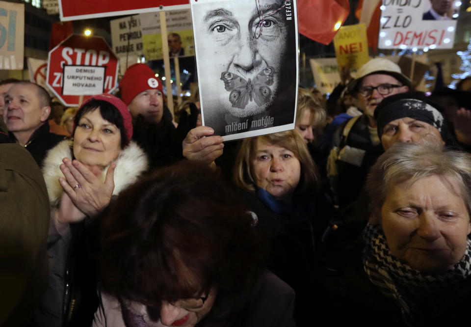 Several thousands demonstrators gather to demand the resignation of Czech Republic's Prime Minister Andrej Babis, at the Wenceslas square in Prague, Czech Republic, Tuesday, Dec. 10, 2019. Babis faces legations that he has misused EU subsidies for a farm he transferred to his family members, though he denies wrongdoing. (AP Photo/Petr David Josek)