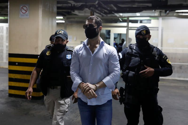 Luis Enrique, one of the sons of former Panamanian President Ricardo Martinelli, is escorted by police officers after being detained along with his brother Ricardo to face extradition to the U.S. on money laundering charges, in Guatemala City