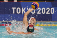 Japan's Toi Suzuki, top, protects the ball from Hungary's Daniel Angyal, bottom, during a preliminary round men's water polo match at the 2020 Summer Olympics, Tuesday, July 27, 2021, in Tokyo, Japan. (AP Photo/Mark Humphrey)