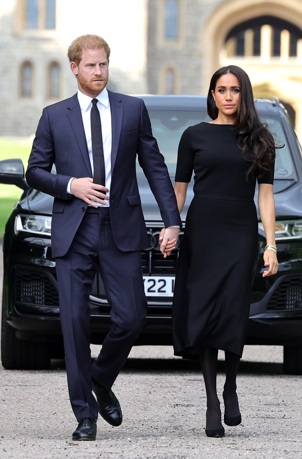 Prince Harry, Duke of Sussex, and Meghan, Duchess of Sussex arrive on the long Walk at Windsor Castle arrive to view flowers and tributes to HM Queen Elizabeth on September 10, 2022 in Windsor, England.