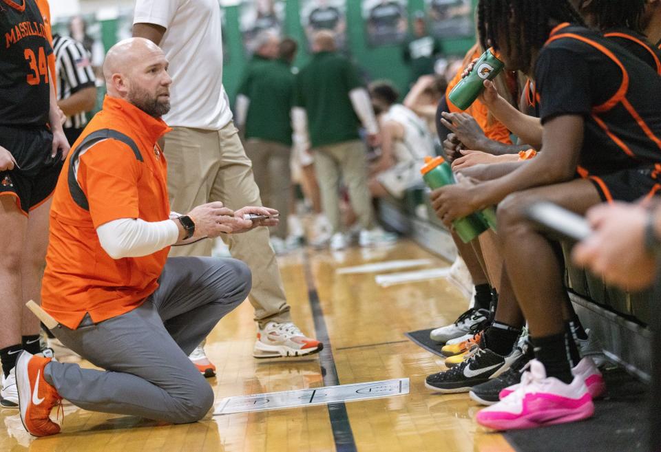 Massillon head coach Josh Hose draws up a play during Friday's game against Central Catholic.