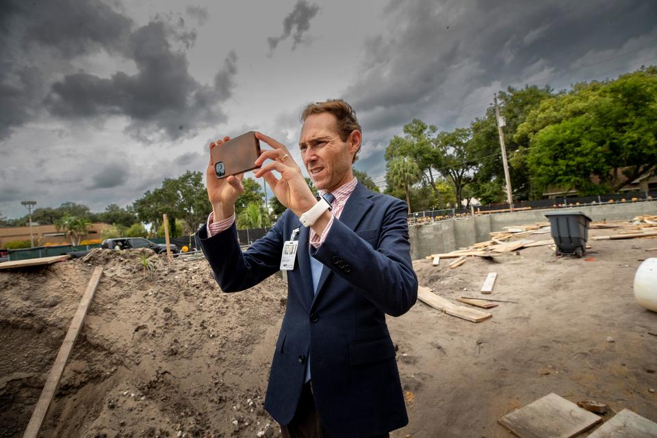 H. Alexander Rich, executive director and chief curator of the Polk Museum of Art, snaps a photo of the construction on a recent afternoon. The expansion of the 1988 structure will greatly increase gallery space at the Lakeland museum.