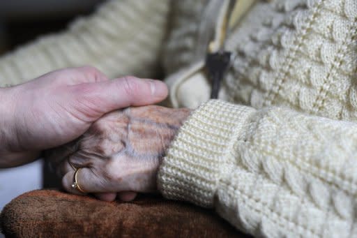 A woman, suffering from Alzheimer's desease, holds the hand of a relative in a retirement house in Angervilliers, eastern France. Alzheimer's disease causes two-thirds of dementia cases -- attacking one in 200 people -- and finding a cure has never been more pressing as the world's population grows and ages