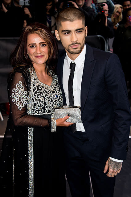 Zayn Malik has a brand-new look following his One Direction departure. The 22-year-old singer attended the Asian Awards in London on Friday with his mom, where he also debuted his newly shaved head and nose ring. Check out the former boy band member looking sharp in a navy blue suit and a stylish black skinny tie. Getty Images Getty Images PHOTOS: Quitting the Band -- Musicians Who Left Popular Boy Bands Zayn's fiancée -- Little Mix member Perrie Edwards , who wasn’t seen at the event -- also has a nose piercing on the right side of her nose. The last time Zayn walked a red carpet was at the 16th NRJ Music Awards on Dec. 13, 2014, alongside his former bandmates Niall Horan, Liam Payne and Harry Styles. Louis Tomlinson was not present at the time. Last night on <em>The Late Late Show with James Corden</em>, Simon Cowell -- who is credited with forming One Direction on the British <em>X Factor</em> -- joked that he was "about to jump off a cliff" when he heard the news that Zayn wanted to leave One Direction. But unlike plenty of devastated 1D fans, he said he wasn't exactly surprised. "I kind of knew this was coming if I was being honest with you," Cowell admitted. "We had a few conversations. He wasn't happy and I was trying to say to him, 'Look, I think you should stay around a bit longer.' And then something just in him said, 'I had enough,' and then once the decision was made I dealt with it." PHOTO: One Direction Releases First Official Photo Without Zayn Malik Check out a then 17-year-old Zayn already showing his unease at being part of a boy band during his season of the <em>X Factor</em> in the video below.