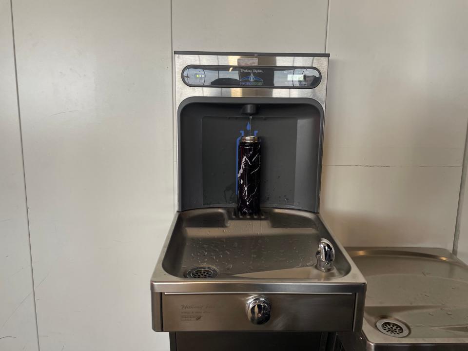 Filling up water bottle at a fountain in Boston Logan Airport Asia London Palomba PLAY airlines review