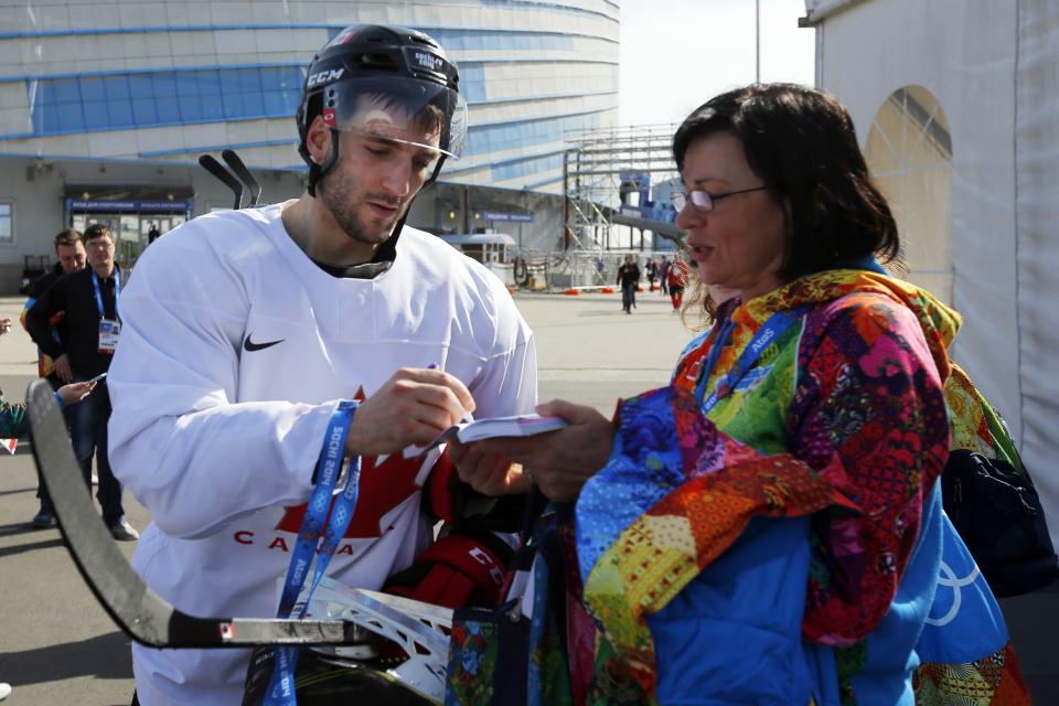 Canada's ice hockey player Patrice Bergeron signs an autograph following a men's team practice at the 2014 Sochi Winter Olympics February 20, 2014. REUTERS/Brian Snyder (RUSSIA - Tags: SPORT OLYMPICS ICE HOCKEY)