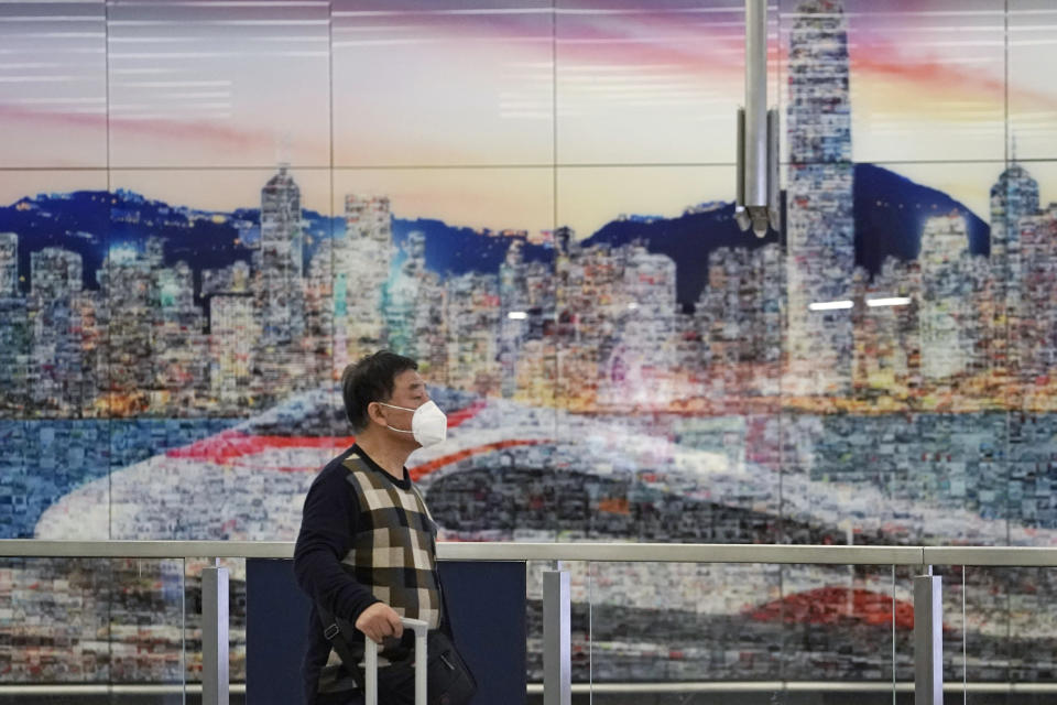 A passenger wears mask at the high speed train station, in Hong Kong, Wednesday, Jan. 22, 2020. Hong Kong's Department of Health on Wednesday confirmed its first case of the new strain of coronavirus, which has been spreading in China. (AP Photo/Kin Cheung)