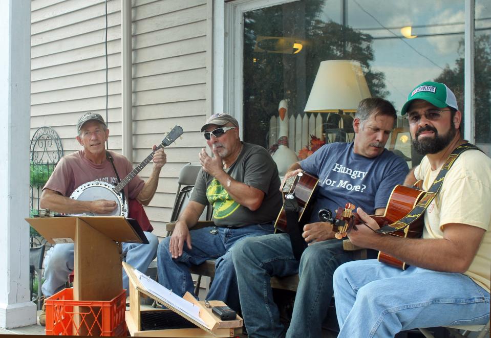 
From left, Mike Neuroth of Tuckerton on banjo, Tony DeCroce of Barnegat doing vocals, Don Sheppard, leader of the group, from Chatsworth and Mike Dougherty of West Creek play on the porch of Buzby's General Store during the Cranberry Festival.
