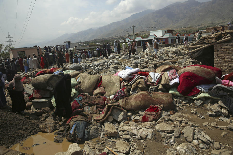 Rescuers search for bodies after a mudslide during heavy flooding in Parwan province, north of Kabul, Afghanistan, Wednesday, Aug. 26, 2020. Flooding in northern Afghanistan killed and injured dozens of people officials said Wednesday. (AP Photo/Rahmat Gul)