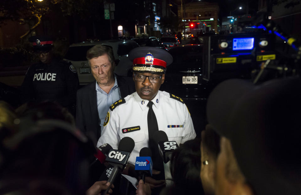 <em>Police Chief Mark Saunders (centre) and Toronto Mayor John Tory (centre left) speak to the media following the mass shooting (AP)</em>