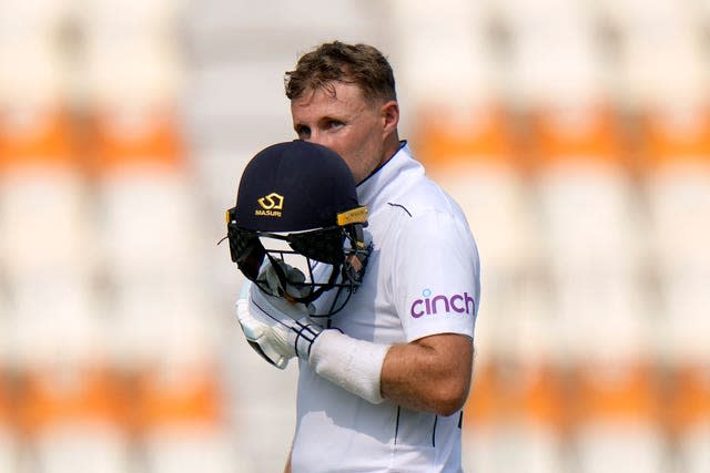 Root kisses his helmet in celebration after scoring his century