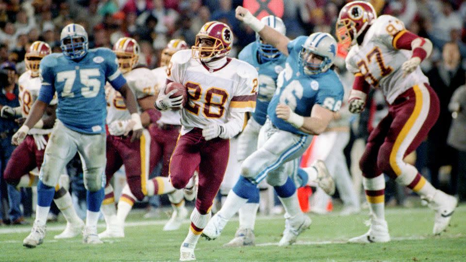 Cornerback Darrell Green (middle) runs an interception back for a touchdown as the Lions lose to then named Washington Redskins in the NFC Championship in 1992. - Rich Lipski/The Washington Post/Getty Images