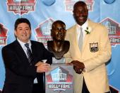 FILE PHOTO: Former San Francisco 49ers great Jerry Rice poses with former 49ers owner Eddie DeBartolo Jr. and his bust after being accepted into the Pro Football Hall of Fame in Canton