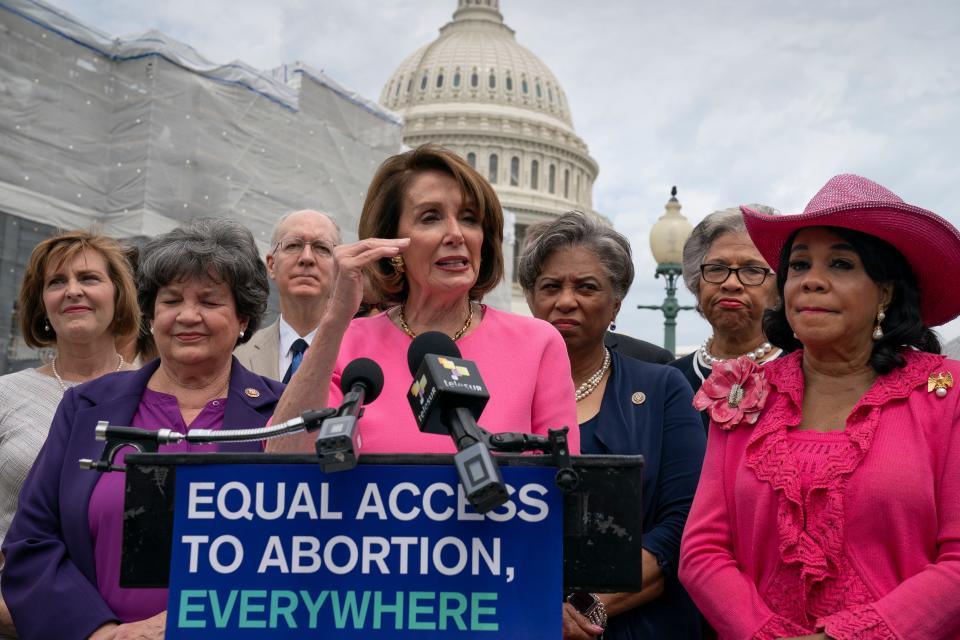Speaker of the House Nancy Pelosi, D-Calif., center, flanked by Rep. Lois Frankel, D-Fla., left, and Rep. Frederica Wilson, D-Fla., right, joins members of the Democratic Women's Caucus and the Pro-Choice Caucus at a news conference on Roe vs. Wade and women's rights, at the Capitol in Washington, Thursday, May 23, 2019.