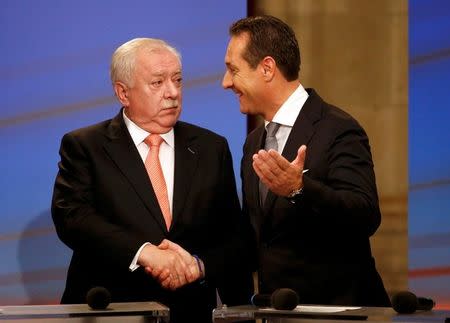 Mayor and province governor of Vienna Michael Haeupl (L) of the Social Democratic Party (SPOe) and Head of the Austrian Freedom Party (FPOe) Heinz-Christian Strache react after a TV debate after the first projections during regional elections in Vienna, Austria, October 11, 2015. REUTERS/Leonhard Foeger