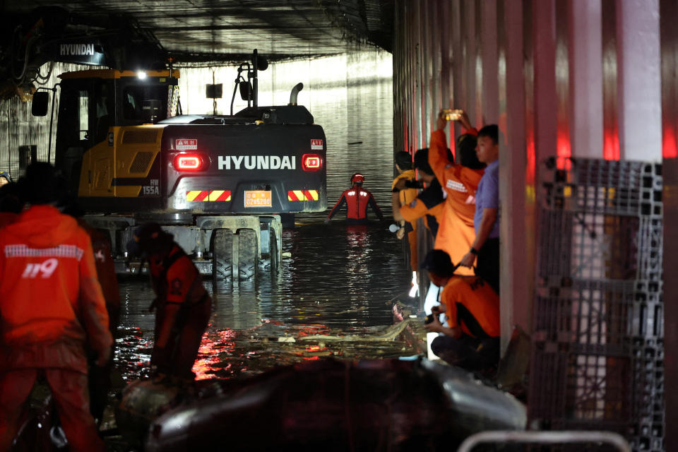 Rescue workers take part in a search and rescue operation inside an underpass that was submerged by a flooded river caused by torrential rain in Cheongju, South Korea, July 17, 2023. / Credit: Yonhap via REUTERS