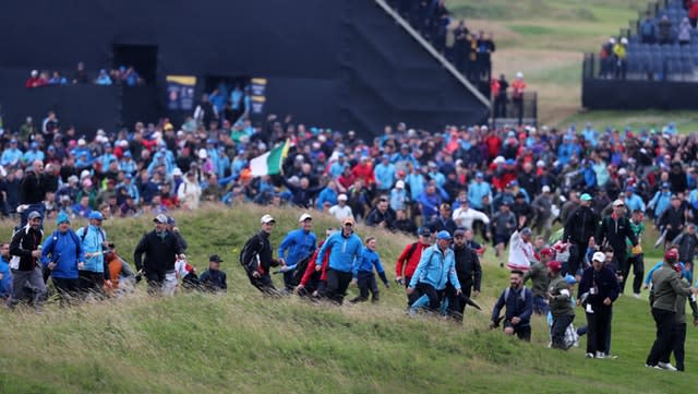 Fans rush on to the course 