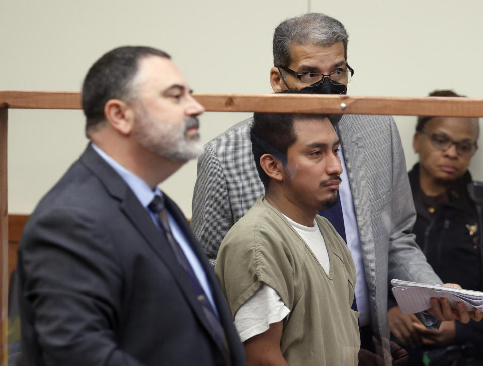 Gerson Fuentes, center, the man accused of raping a 10-year-old girl who then traveled to Indiana to have an abortion, appears between his lawyer Bryan Bowen, left, and his interpreter in Franklin County common pleas court for his bond hearing in Columbus, Ohio, Thursday, July 28, 2022. Judge Julie Lynch denied bond. (AP Photo/Paul Vernon)