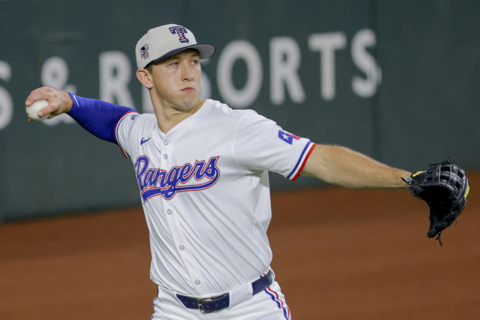 Texas Rangers outfielder Wyatt Langford catches a fly ball from San Diego Padres' Jackson Merrill during the fourth inning of a baseball game Thursday, July 4, 2024, in Arlington, Texas. (AP Photo/Gareth Patterson)