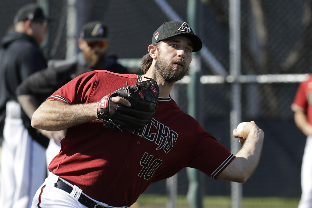 Arizona Diamondbacks' Madison Bumgarner throws during spring training baseball practice, Sunday, Feb. 16, 2020, in Scottsdale, Ariz. (AP Photo/Darron Cummings)