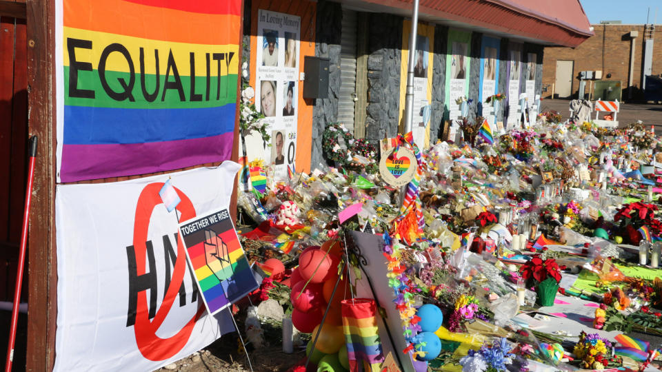 Bouquets, balloons and banners at the closed entrance to Club Q.