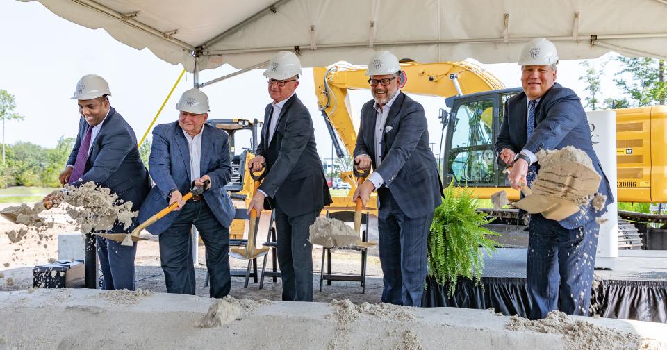 Representatives of Mayo Clinic, Hilton Hotels and the builders and developers of a new Hilton on the hospital campus break ground on what will be a $70 million lodging.