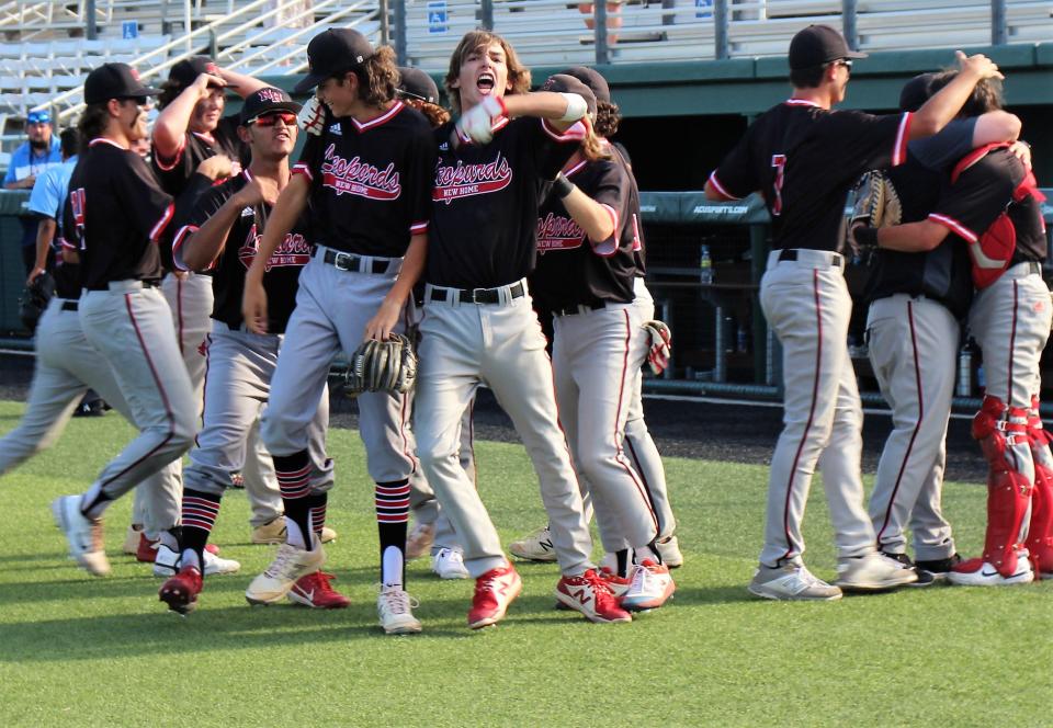 Pitcher Owen Morris, who saved Saturday's Game 3 win over Anson, is cheered, left while catcher Ryan Bundy, whose catch in foul territory ended the game, is hugged by coach Brady Webb. New Home won 13-12 to advance to the Region I-2A final against Albany.