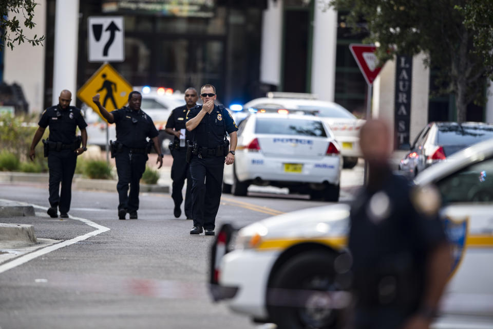 Police gather after an active shooter was reported at the Jacksonville Landing in Jacksonville, Florida, on Sunday. (AP) 