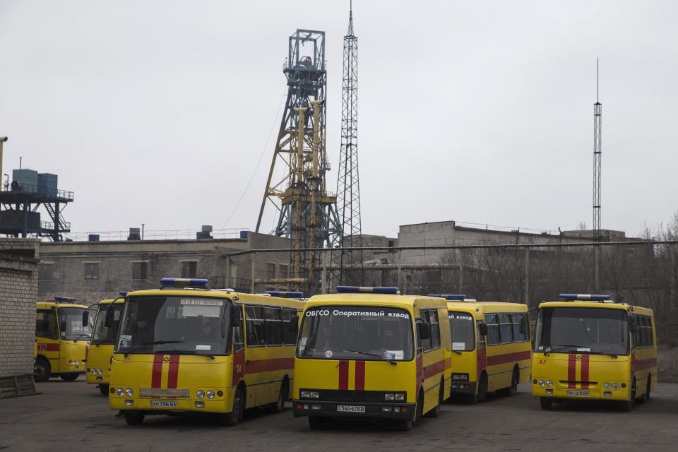 Emergency vehicles are pictured parked outside Zasyadko coal mine in Donetsk March 4, 2015. A blast at the coal mine in the eastern Ukrainian rebel stronghold of Donetsk killed more than 30 people, a local official said on Wednesday, with dozens more miners who were underground at the time unaccounted for. (REUTERS/Baz Ratner)