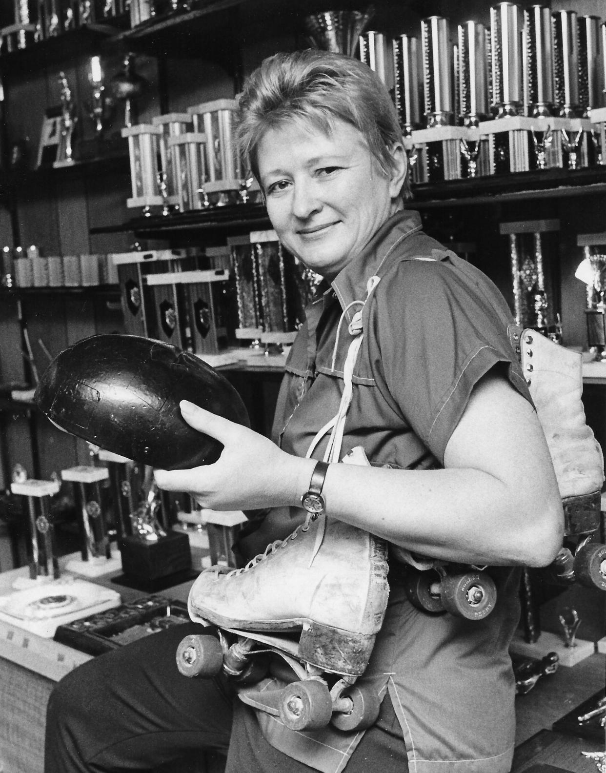 Former roller derby star Joan Kazmerski holds up her old helmet and skates in 1975 at Kaz-Nor Awards in Kent.