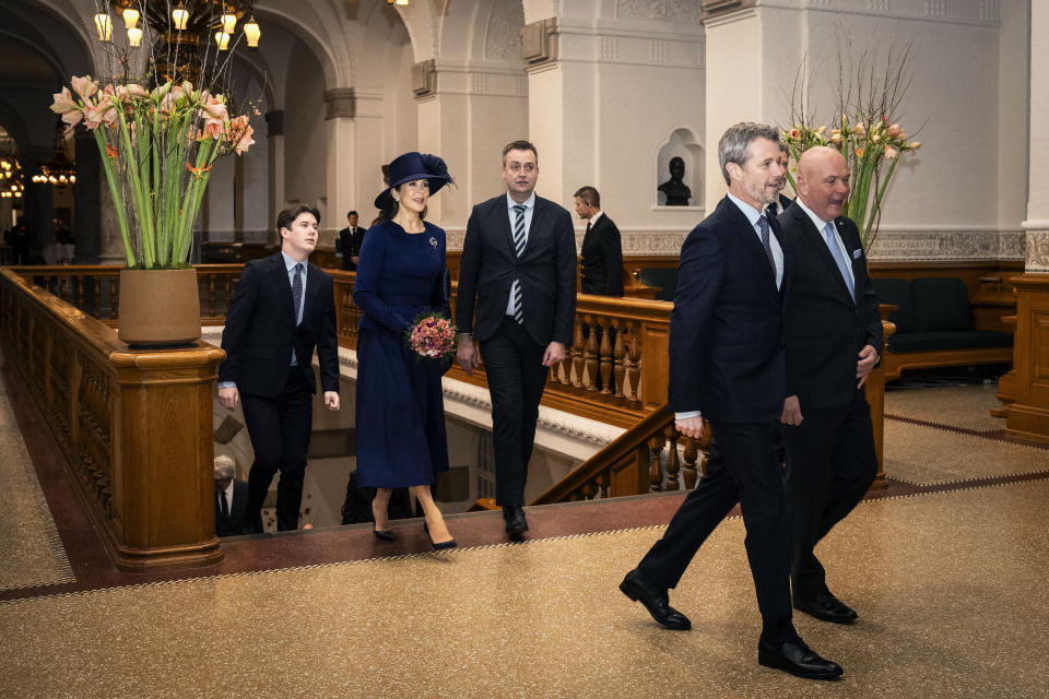 Denmark's King Frederik X, foreground left, Queen Mary, background centre and Crown Prince Christian, left arrive with Speaker of the Folketing Soeren Gade, right, at the Folketingsalen at Christiansborg Palace in Copenhagen, Monday, Jan. 15, 2024, their first time visiting in their new official roles. (Emil Nicolai Helms/Ritzau Scanpix via AP)