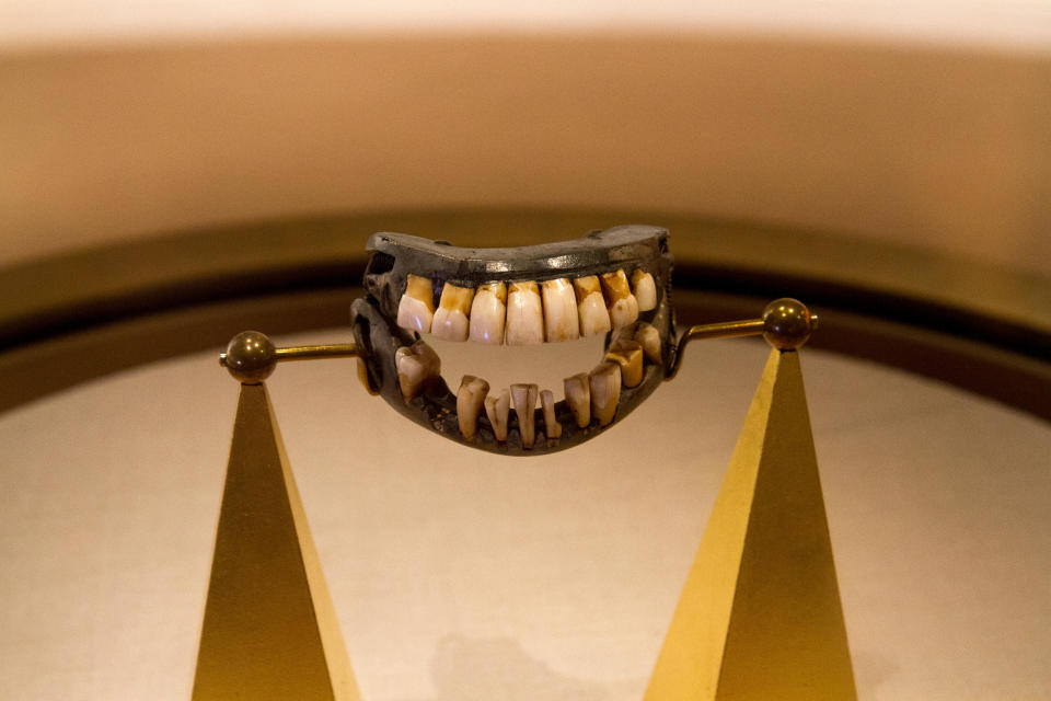 Dentures worn by George Washington, displayed on a stand in a museum exhibit