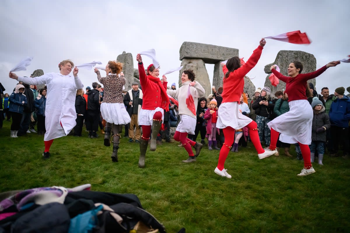 A Morris dance group performs near the standing stones at Stonehenge (Getty Images)