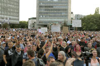 FILE - In this Sept 15, 2021, file photo, protesters gather near parliament in Ljubljana, Slovenia. In Slovenia, hundreds of anti-vaccination protesters hurled flares at the parliament building to protest new measures that require a COVID pass for entering almost any shop, service or a workplace in the country. (AP Photo/File)