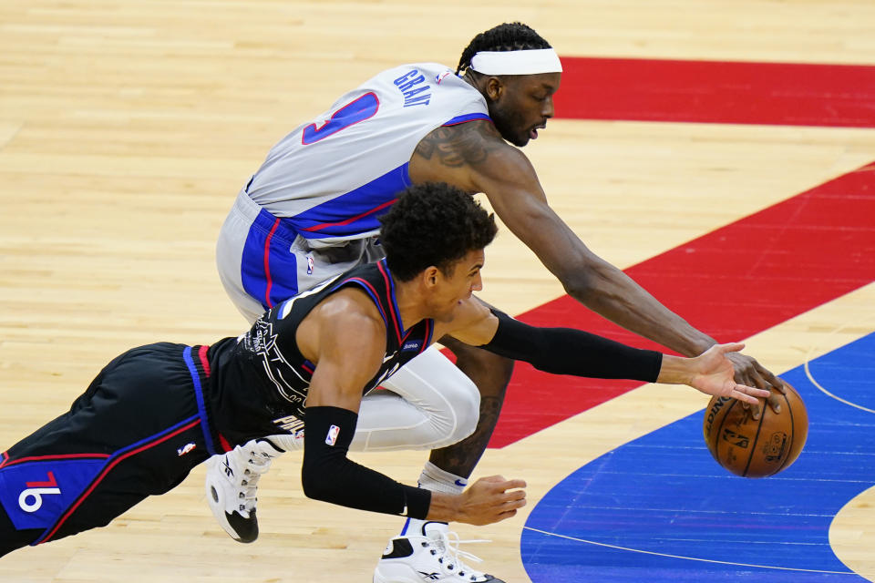 Philadelphia 76ers' Matisse Thybulle, left, dives for the ball against Detroit Pistons' Jerami Grant during the second half of an NBA basketball game, Saturday, May 8, 2021, in Philadelphia. (AP Photo/Matt Slocum)