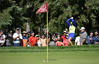 Paula Reto, of South Africa, raises her golf club over her head as fans shout, after her chip came up short on the green of the 17th hole during the final round of the Canadian Pacific Women's Open golf tournament in Ottawa, on Sunday, Aug. 28, 2022. (Justin Tang/The Canadian Press via AP)