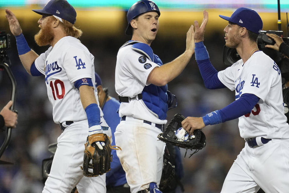 Los Angeles Dodgers congratulate each other at the end of Game 3 of baseball's National League Championship Series Tuesday, Oct. 19, 2021, in Los Angeles. The Dodgers defeated the Braves 6-5. The Braves lead the series 2-1 games. (AP Photo/Ashley Landis)