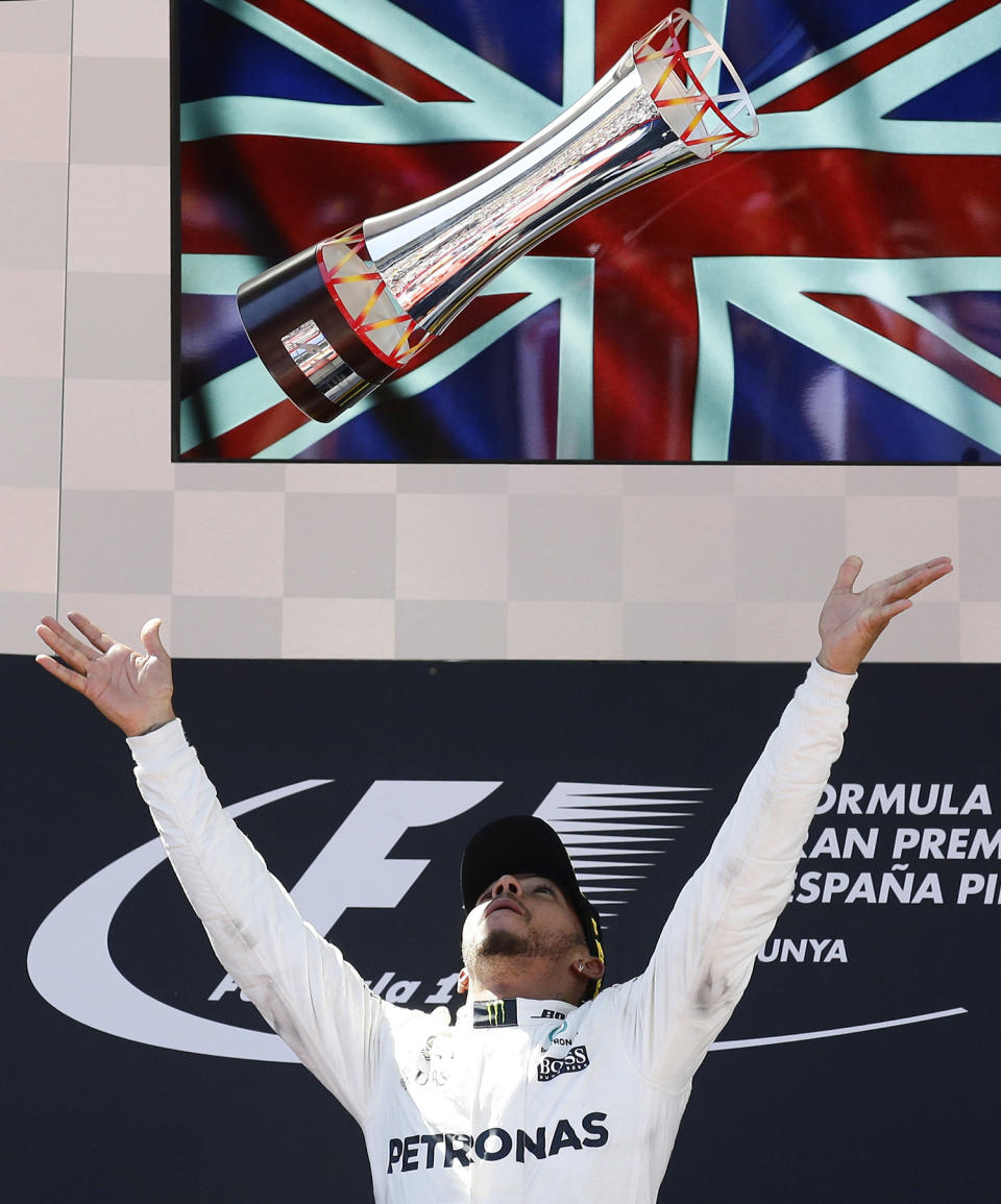 <p>Mercedes driver Lewis Hamilton of Britain throws his trophy into the air on the podium after winning the Spanish Formula One Grand Prix at the Barcelona Catalunya racetrack in Montmelo, Spain, Sunday, May 14, 2017. (Photo: Manu Fernandez/AP) </p>