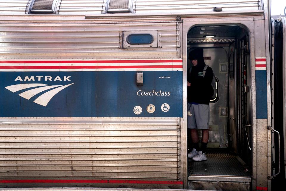 A traveler boards an Amtrak train in Wilmington, Delaware, on April 22, 2022. (Photo by Stefani Reynolds / AFP) (Photo by STEFANI REYNOLDS/AFP via Getty Images) ORG XMIT: 0 ORIG FILE ID: AFP_328R7NH.jpg