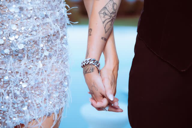 <p>Nazrin Massaro</p> Chrishell Stause and G Flip hold hands