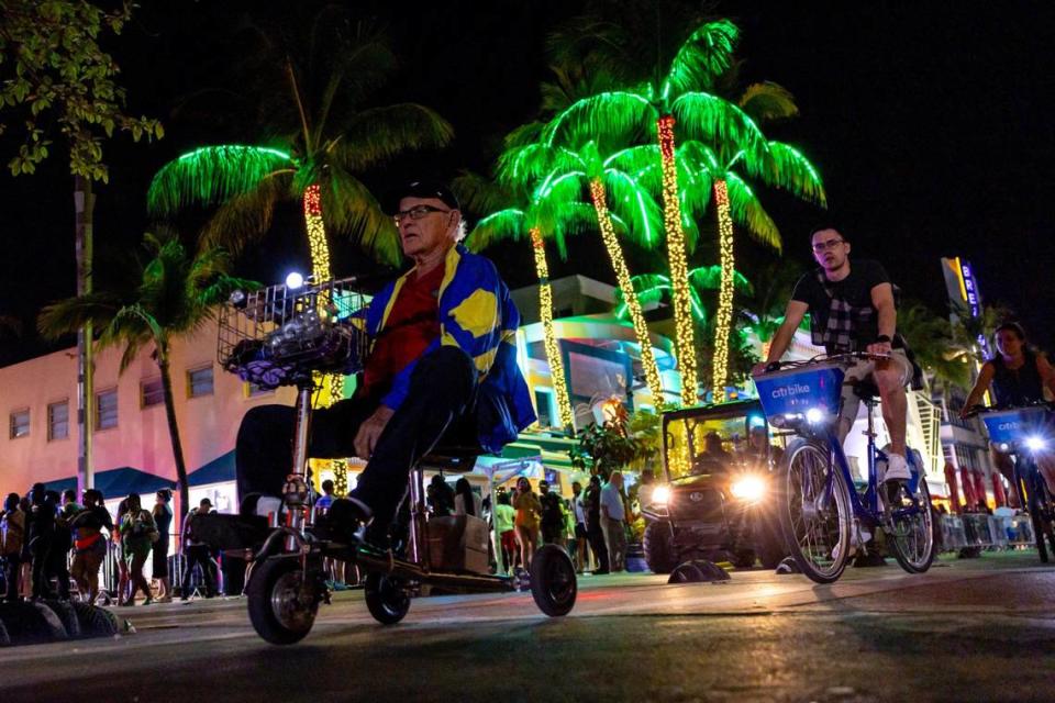 Miami Beach resident John Parker, 88, rides down Ocean Drive during spring break in Miami Beach on Friday, March 15, 2024.