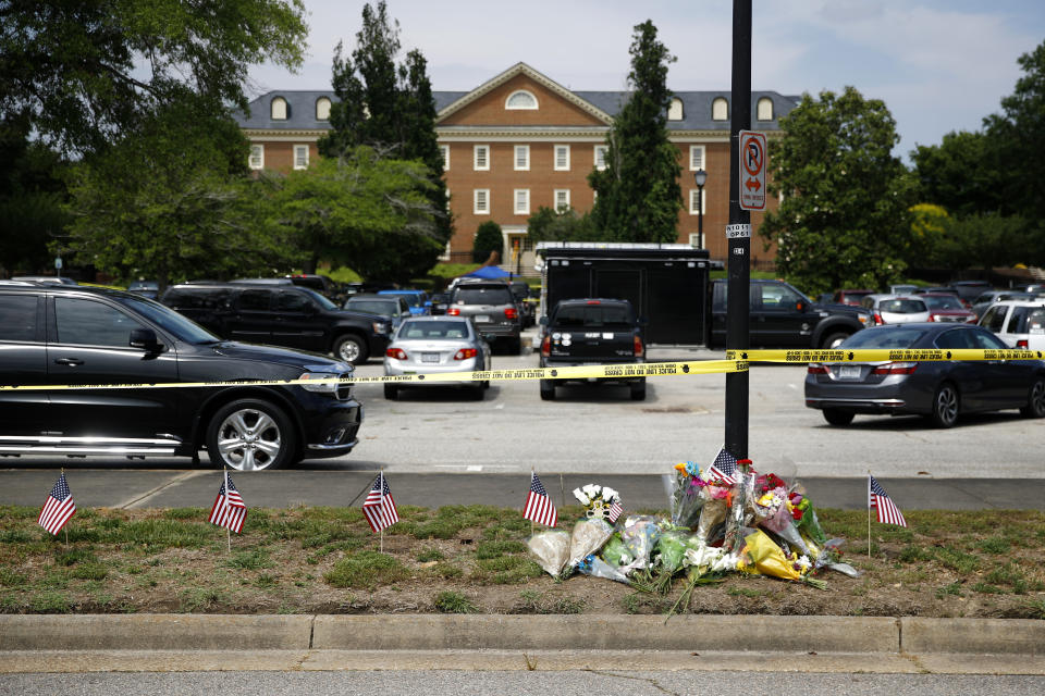 FILE - In this June 1, 2019, file photo, a makeshift memorial rests at the edge of a police cordon in front of a municipal building that was the scene of a shooting in Virginia Beach, Va. The Virginia Beach killing is one of 11 mass workplace killings dating back to 2006 in the U.S., according to a database of mass killings maintained through a partnership between AP, USA Today and Northeastern University. (AP Photo/Patrick Semansky, File)