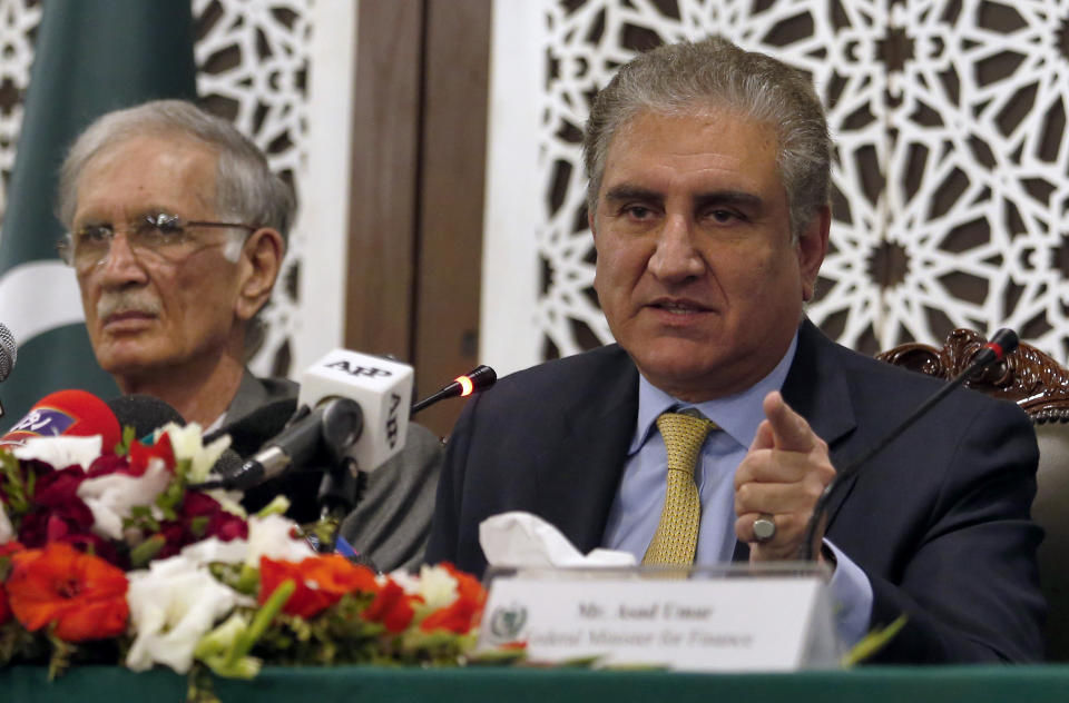 Pakistani Foreign Minister Shah Mahmood Qureshi, right, gives a press conference with Defense Minister Pervez Khattak, left, and Finance Minister Asad Umar after a recent Indian airstrike, in Islamabad, Pakistan, Tuesday, Feb. 26, 2019. Pakistan said India launched an airstrike on its territory early Tuesday that caused no casualties, while India said it targeted a terrorist training camp in a pre-emptive strike that killed a "very large number" of militants. (AP Photo/Anjum Naveed)