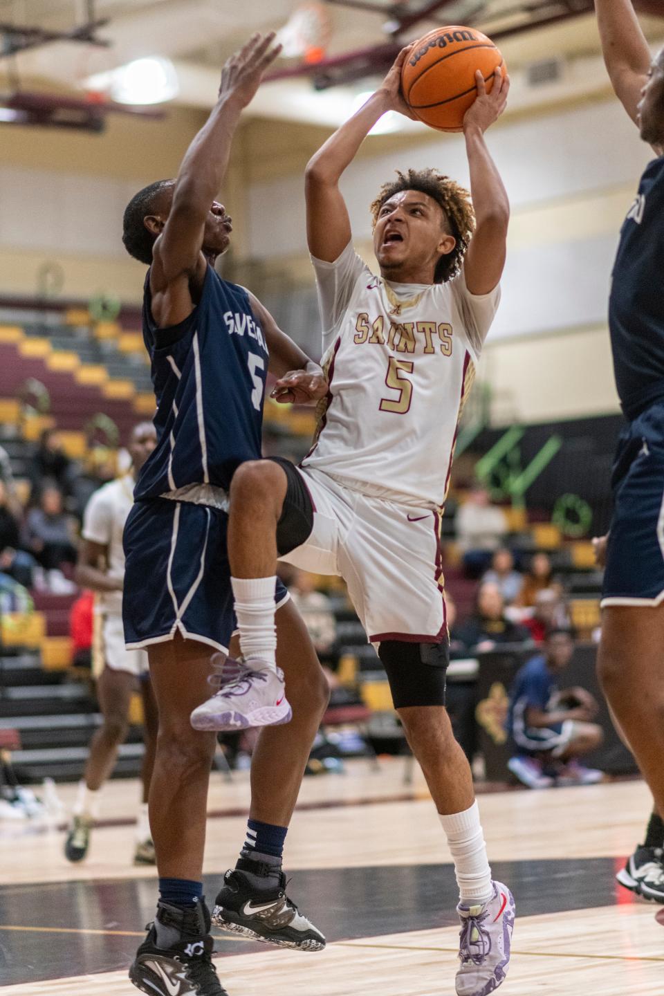 Adelanto’s Jordan Malveaux drives the lane while guarded by Silverado’s Jarmarri Tharpe on Friday, Jan. 13, 2023. Adelanto won 53-48.