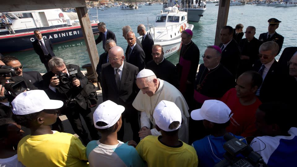 Pope Francis talks with migrants at Lampedusa Island, southern Italy, July 8, 2013. - Alessandra Tarantino/Reuters